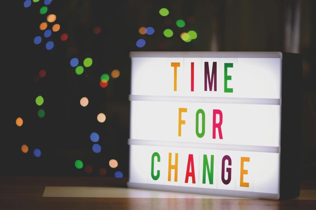 pexels photo 2277784 2277784 Colorful illuminated sign displaying the motivational message 'Time for Change'.